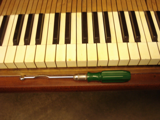 E5 - We fine-regulated key spacing and tightened wobbly keys by turning under-key pins.